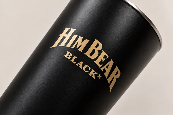 Gold printed logo on a black stainless steel tumbler